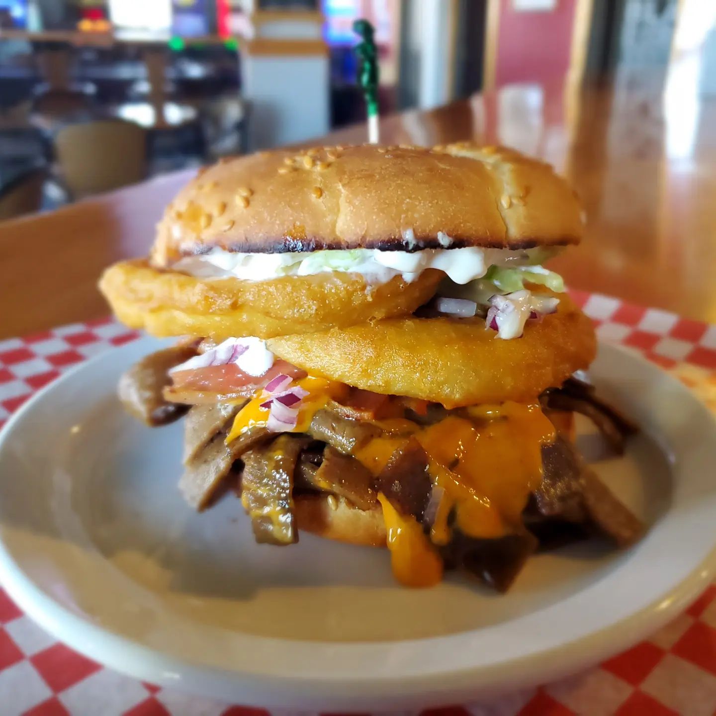 A special burger creation featuring onion rings, melty cheese and the meats!